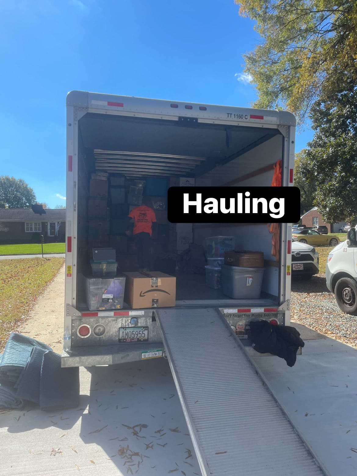 Moving truck packed with boxes for hauling on a sunny day.